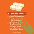 "Open bottle of Airborne 1000mg Vitamin C 64 Chewable Tablets with tablets visible"

