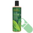 "Desert Essence Tea Tree Replenishing Shampoo bottle with natural tea tree leaf background"

