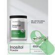 Horbaach Inositol Powder Vitamin B8 8 oz next to glass of water for mixing demonstration.

