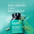 Close-up of Hum Skin Squad capsules inside clear bottle with label.

