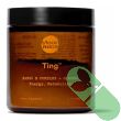 Moon Juice Ting powder container with scoop and fresh herbs highlighting natural botanicals

