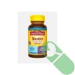 Softgels spilled beside Nature Made Biotin bottle showing capsule size and texture


