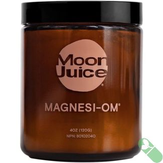 “Moon Juice Magnesi Om jar on wooden table setting”

