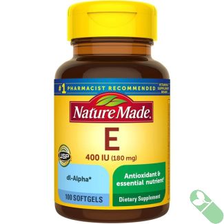 Open bottle of Nature Made Vitamin E 400 IU Softgels with softgels spilling onto white surface.

